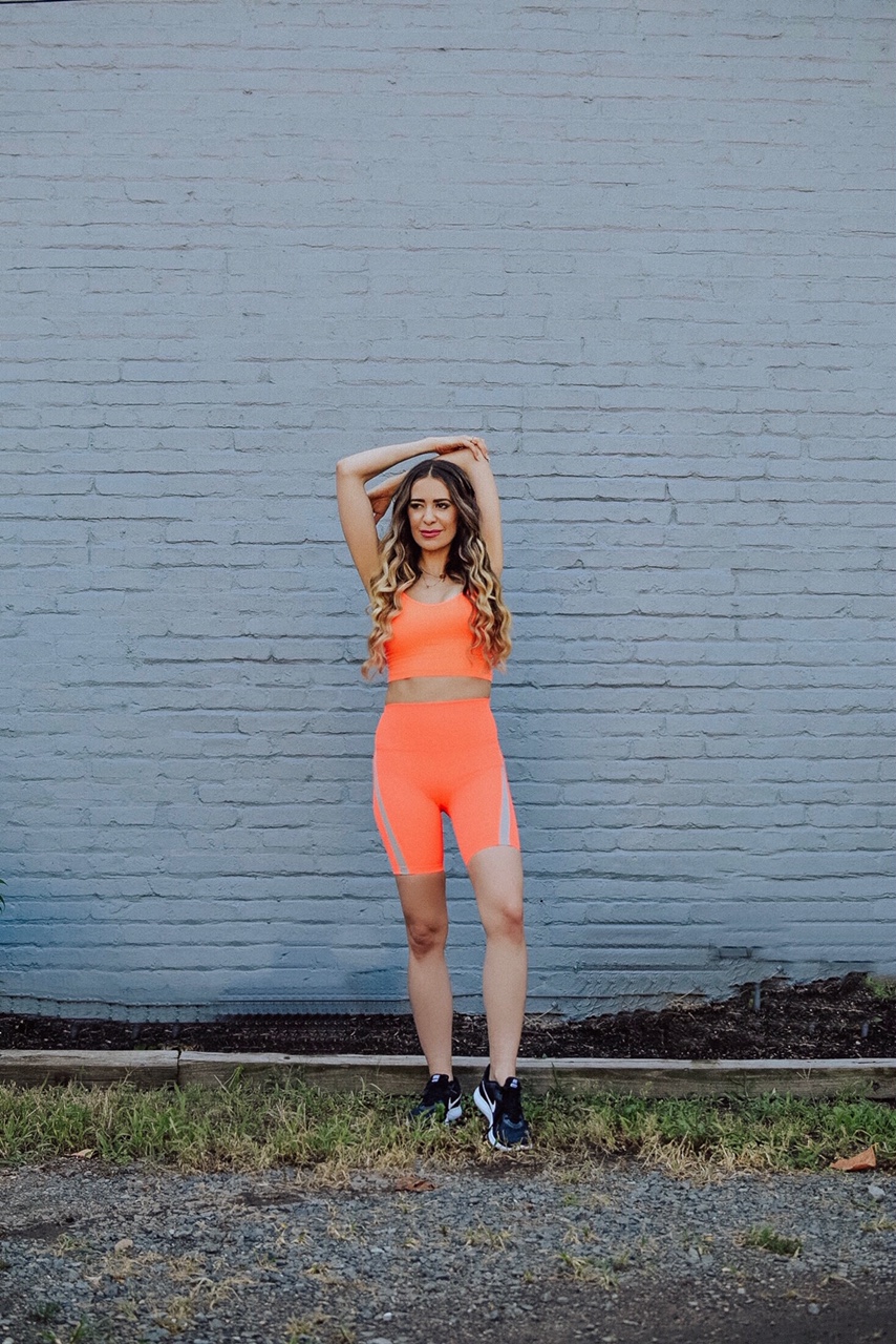 activewear brands you should be wearing, a bright orange color makes you pop at the gym, on a run, and on the street in this activewear