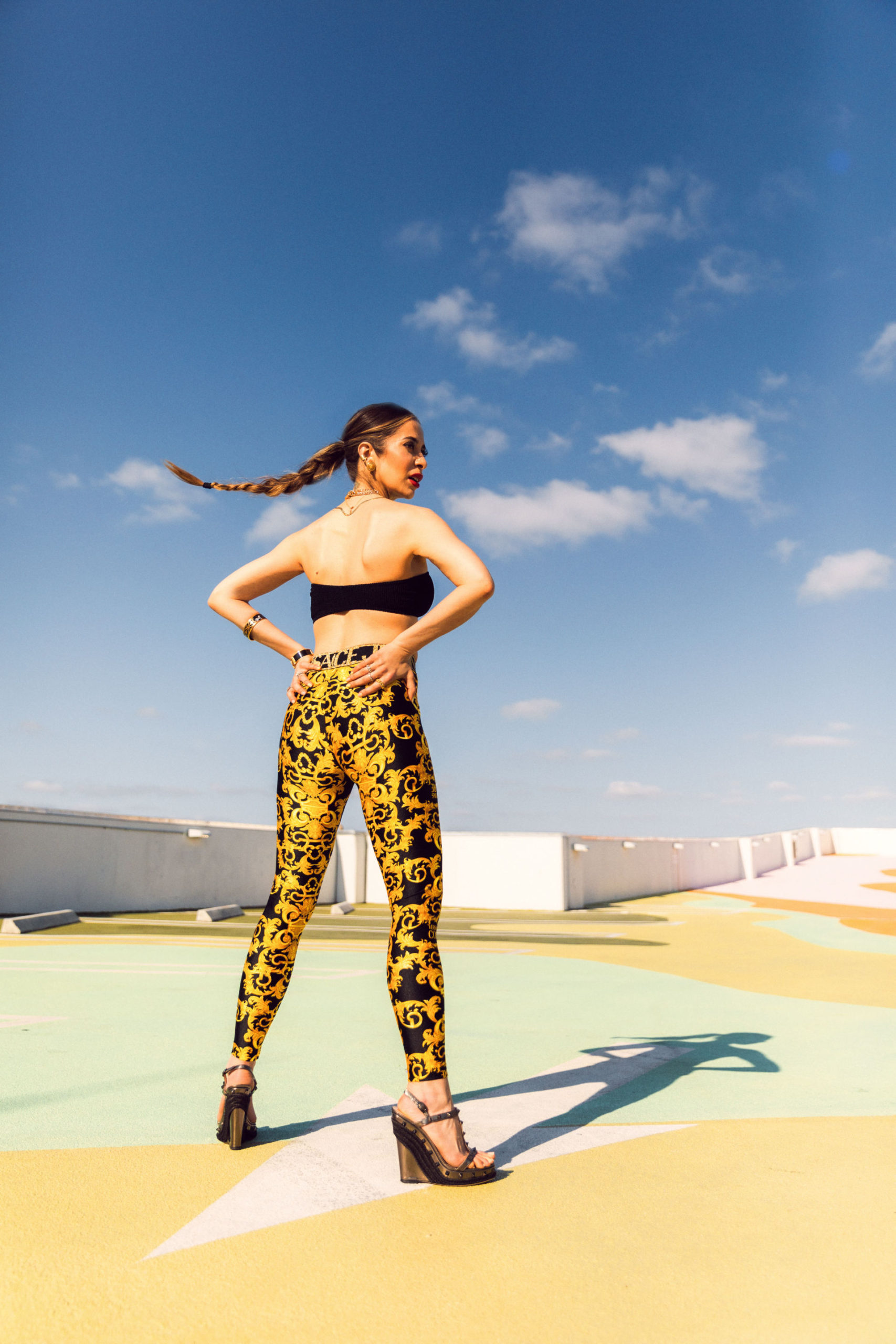 woman wearing black and yellow pants and black tube top
